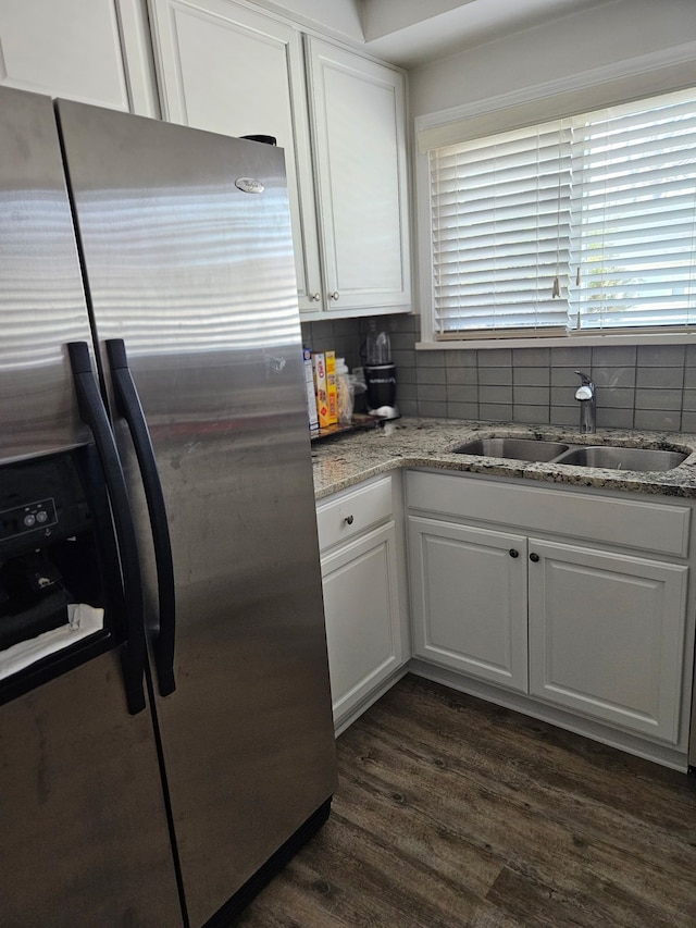 kitchen featuring stainless steel fridge, white cabinets, and a sink