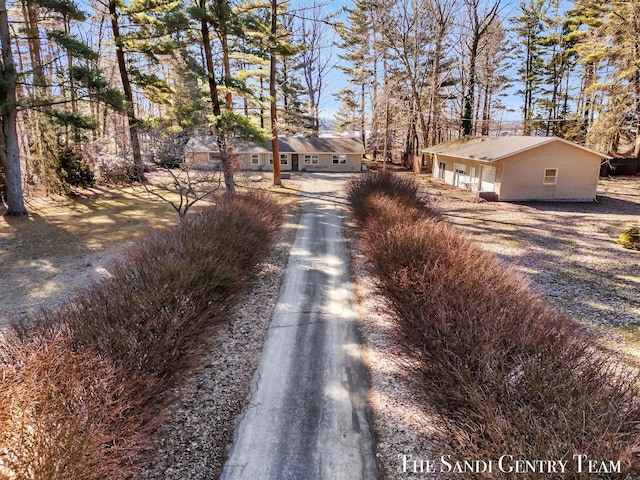 view of street featuring aphalt driveway