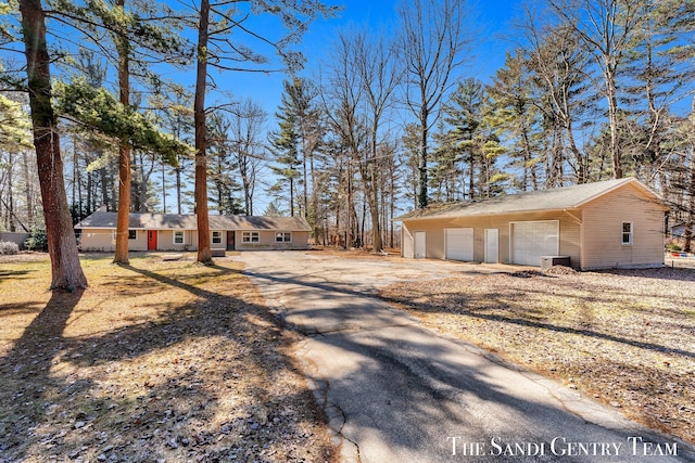 exterior space with an outbuilding, a garage, and central AC