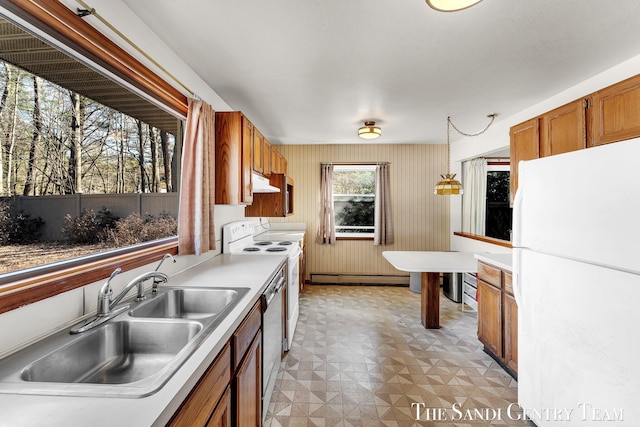 kitchen featuring white appliances, light floors, a baseboard radiator, a sink, and under cabinet range hood