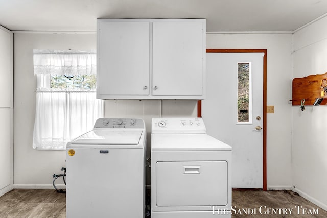 laundry room with washer and clothes dryer, cabinet space, and baseboards