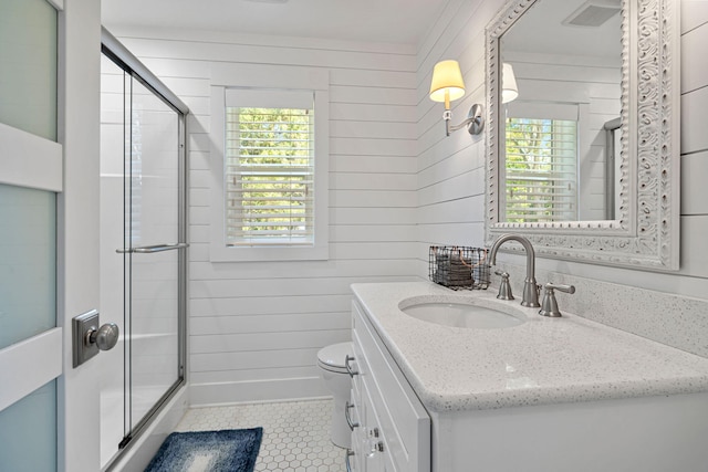 full bath featuring vanity, tile patterned flooring, an enclosed shower, wood walls, and toilet