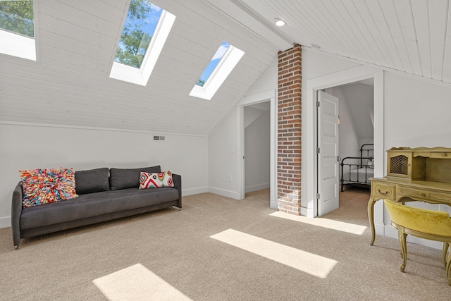 living room with carpet flooring, vaulted ceiling with skylight, baseboards, and visible vents