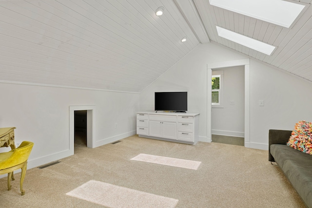 living area featuring baseboards, light carpet, visible vents, and lofted ceiling with skylight