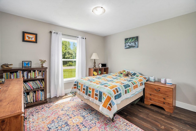 bedroom featuring wood finished floors and baseboards