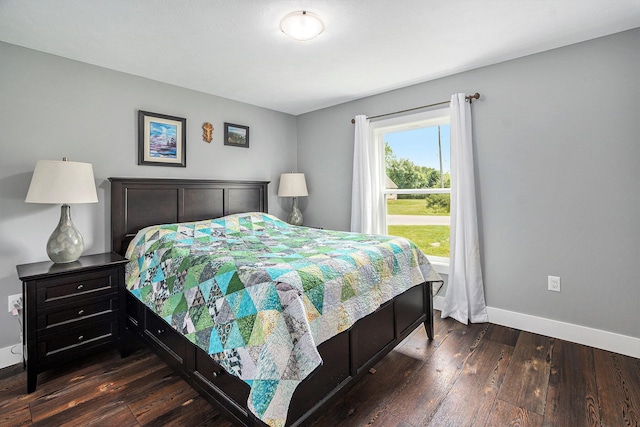 bedroom featuring dark wood-style floors and baseboards