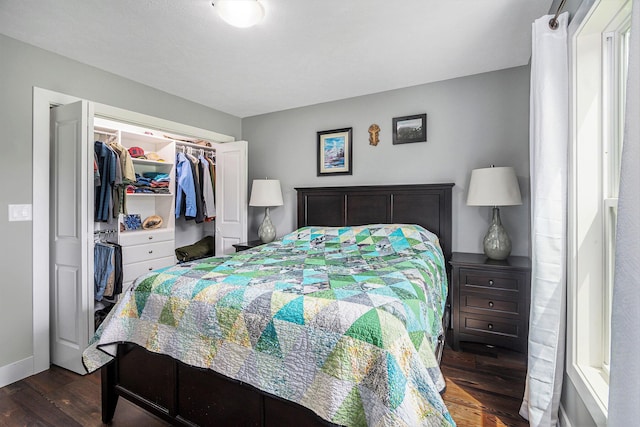 bedroom featuring a closet, baseboards, and dark wood-style flooring