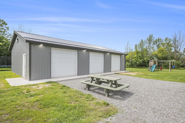 detached garage featuring a trampoline