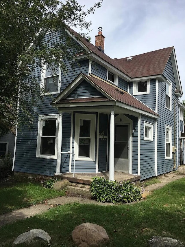 view of front of property featuring a porch and a chimney