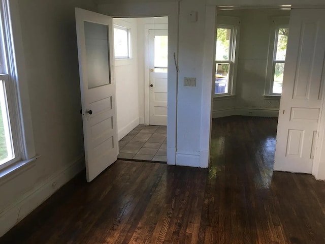 unfurnished room with baseboards and wood finished floors