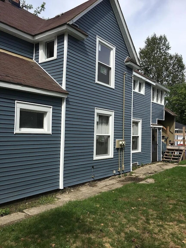 view of home's exterior with a lawn