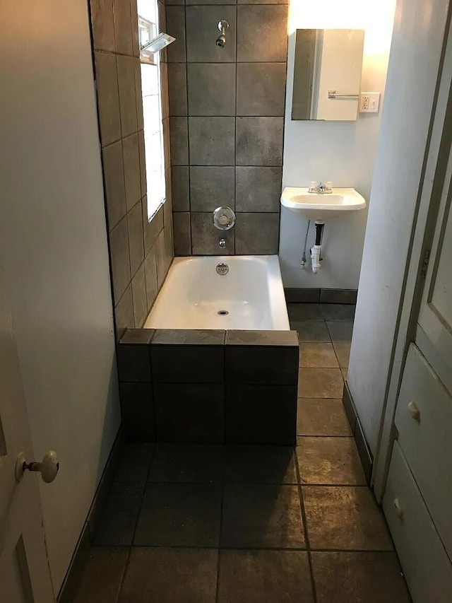 bathroom with a sink and baseboards