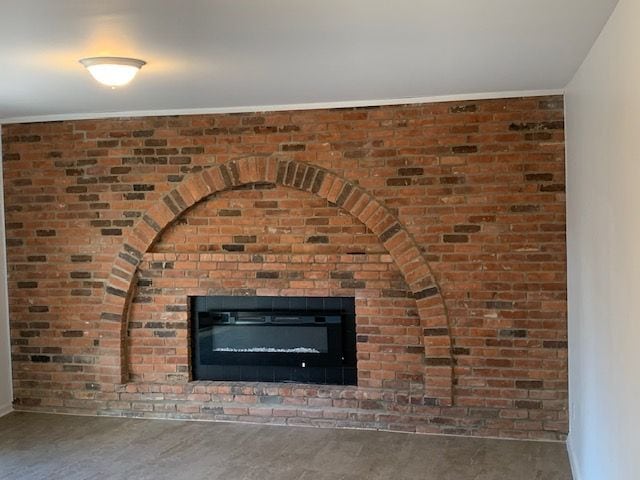 room details featuring a fireplace and crown molding