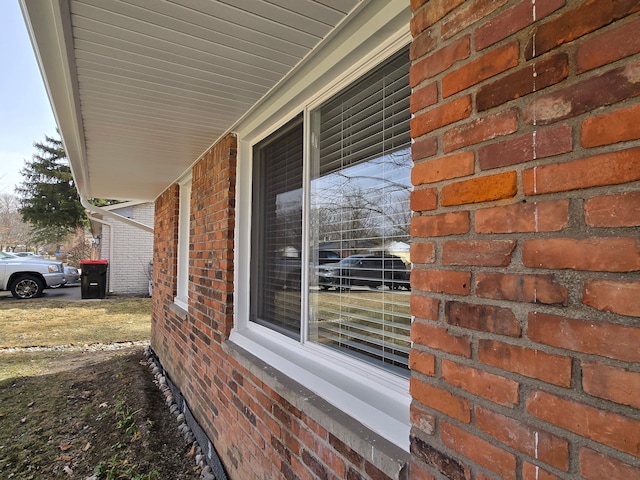 view of exterior entry featuring a porch and brick siding