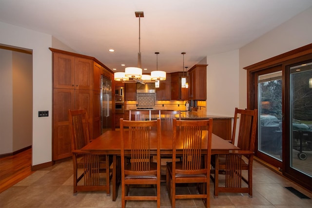 dining space featuring a chandelier, recessed lighting, and baseboards