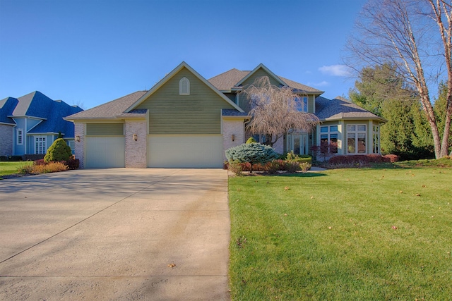 view of front of property with a garage, brick siding, concrete driveway, and a front yard