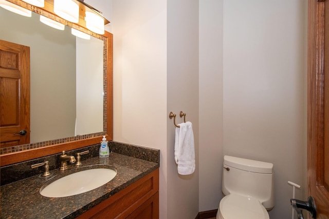 bathroom featuring toilet and vanity