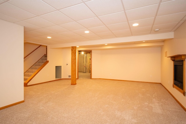 finished below grade area featuring recessed lighting, baseboards, light carpet, and stairs