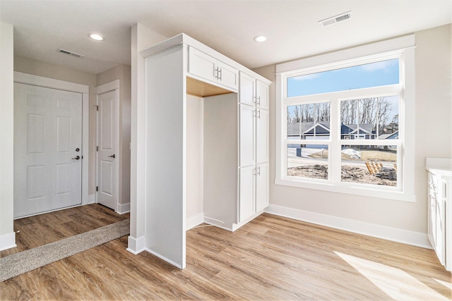 interior space featuring recessed lighting, visible vents, baseboards, and light wood-style floors