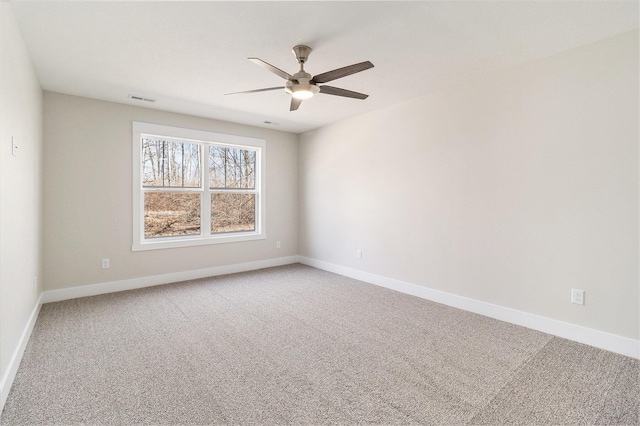 empty room featuring visible vents, light carpet, baseboards, and a ceiling fan