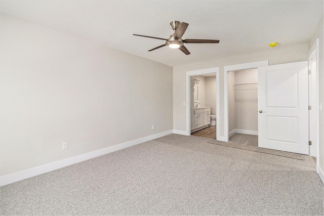 unfurnished bedroom with a ceiling fan, baseboards, a closet, light carpet, and connected bathroom