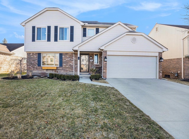 view of front facade with a front yard, brick siding, concrete driveway, and an attached garage