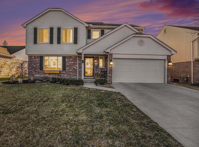 view of front of home featuring an attached garage, brick siding, driveway, and a yard