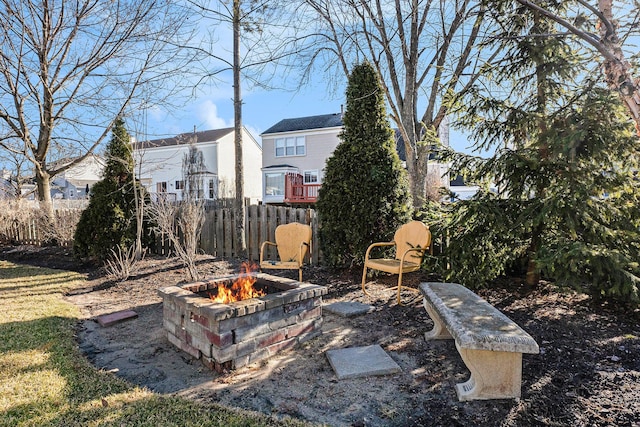 view of yard with an outdoor fire pit and fence