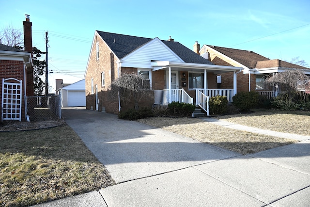 view of front of home featuring a porch, an outdoor structure, a shingled roof, a garage, and brick siding