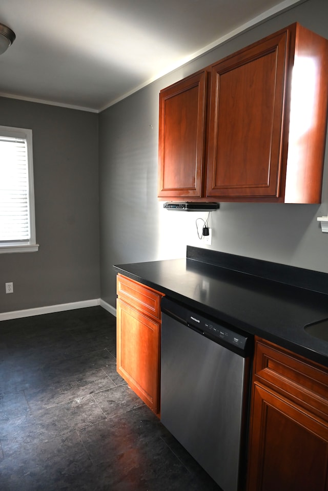 kitchen featuring brown cabinets, stainless steel dishwasher, dark countertops, crown molding, and baseboards