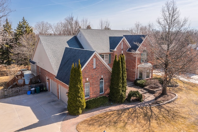 exterior space with fence, driveway, a shingled roof, a garage, and brick siding