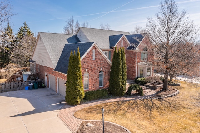 exterior space featuring brick siding, a shingled roof, fence, concrete driveway, and a garage