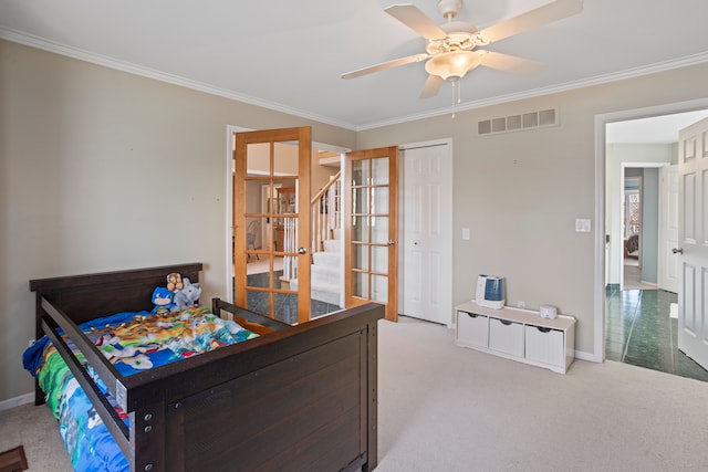 bedroom with visible vents, carpet floors, and crown molding