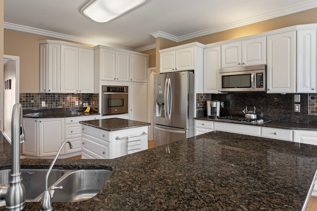 kitchen featuring decorative backsplash, ornamental molding, white cabinetry, and stainless steel appliances