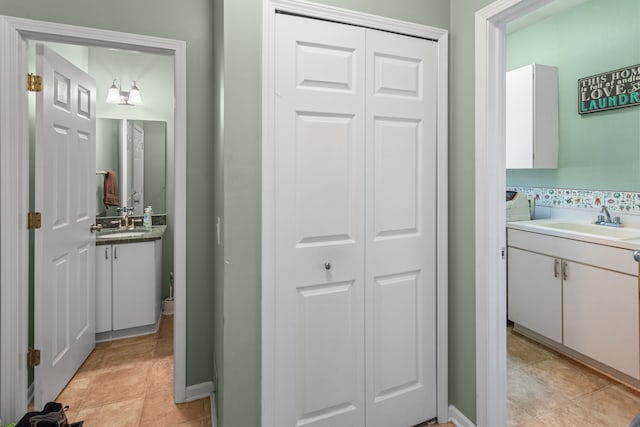 bathroom featuring a sink, a closet, two vanities, and tile patterned flooring