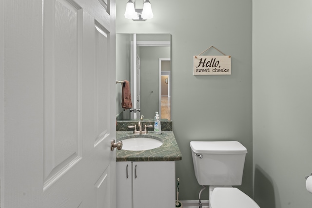 bathroom featuring toilet and vanity