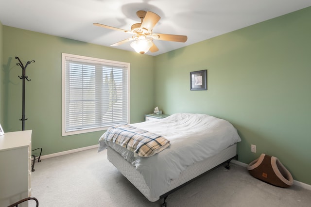 carpeted bedroom featuring baseboards and ceiling fan