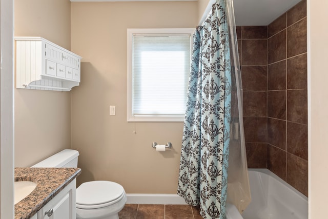 bathroom with vanity, baseboards, tile patterned flooring, shower / bath combo with shower curtain, and toilet