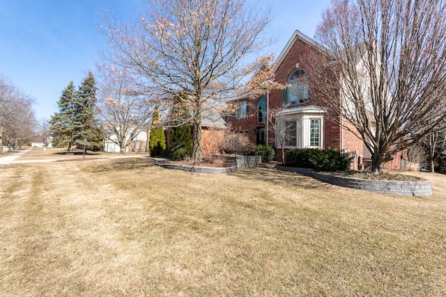 view of front of property with brick siding and a front yard