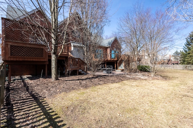 rear view of house featuring stairs, a deck, and fence