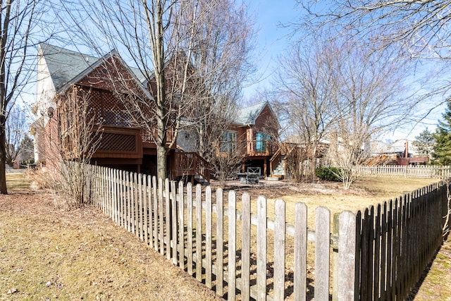 exterior space with a wooden deck and fence private yard