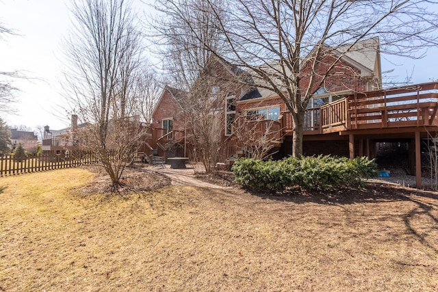 view of yard featuring stairway, a wooden deck, and fence