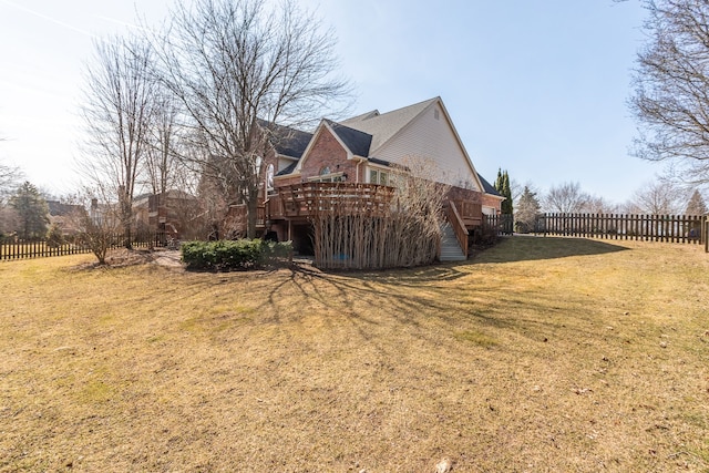 view of home's exterior featuring stairs, a deck, a yard, and fence