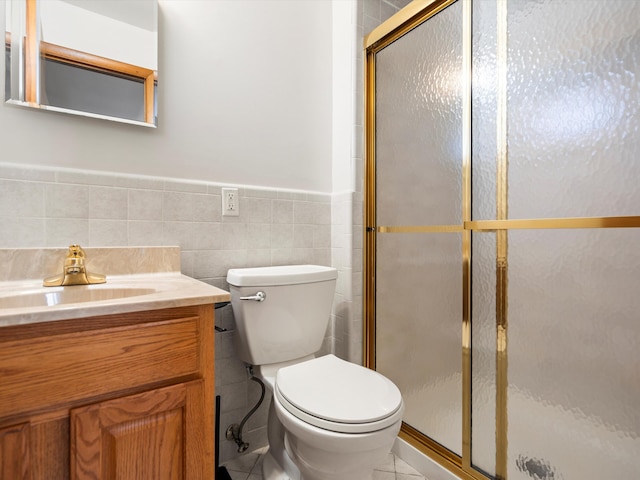 bathroom featuring vanity, tile walls, toilet, and a stall shower