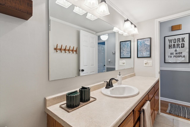 bathroom with tile patterned floors, baseboards, and vanity