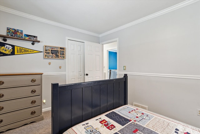 carpeted bedroom with visible vents, a closet, and ornamental molding