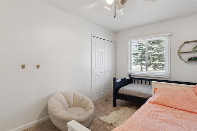 bedroom featuring a ceiling fan, baseboards, a closet, and carpet floors