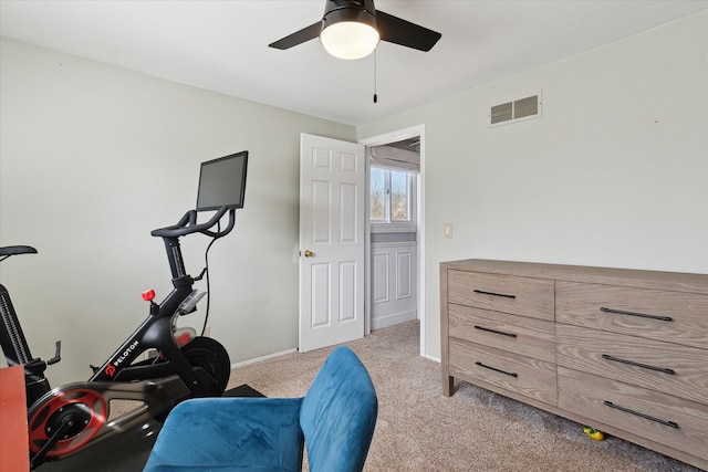 workout area with baseboards, visible vents, carpet floors, and ceiling fan