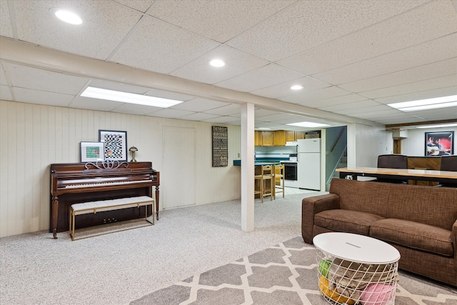 living area featuring stairway, carpet flooring, recessed lighting, and a drop ceiling