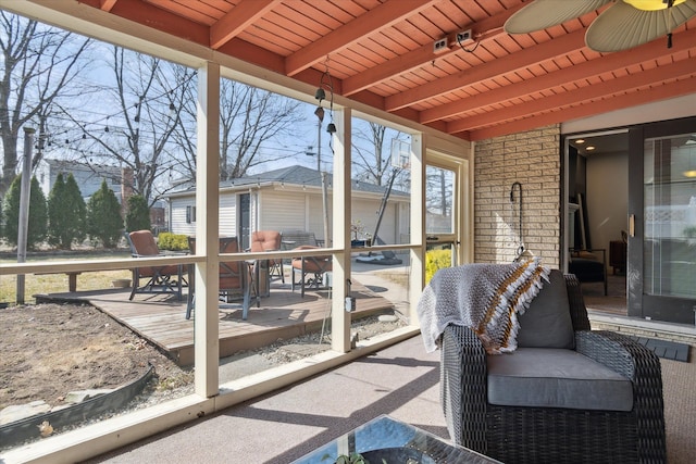 sunroom with beamed ceiling and wooden ceiling